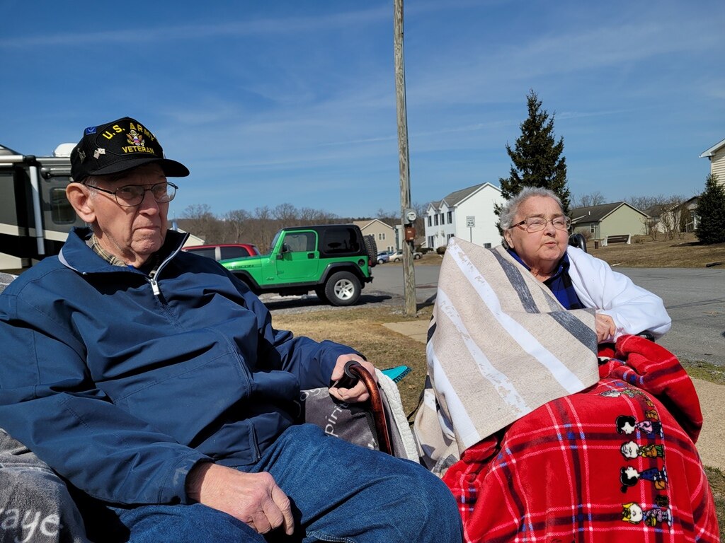 March 2021, it is a warm spring day, Verne and mom sitting outside